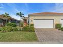 Two-car garage and walkway leading to the front door at 11638 Alessandro Ln, Venice, FL 34293