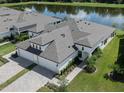 Aerial view of an immaculate home featuring manicured landscaping and a three-car garage at 12586 Oak Hill Way, Parrish, FL 34219