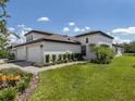 Beautiful home with a well-maintained lawn, lush landscaping, and a three-car garage at 12586 Oak Hill Way, Parrish, FL 34219
