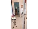 Bright hallway with tile floors and access to other rooms at 5650 Mashie Cir, North Port, FL 34287