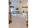 Spacious living room with tile floors and access to a screened porch at 5650 Mashie Cir, North Port, FL 34287