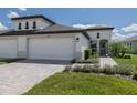 Modern two-car garage house with walkway and landscaping at 12586 Oak Hill Way, Parrish, FL 34219