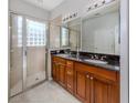 Bathroom boasts double sinks, granite countertop, and shower at 126 Cipriani Way, North Venice, FL 34275