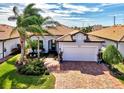 Single-Gathering home with brick driveway and lush landscaping at 13889 Rinuccio St, Venice, FL 34293