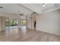 Spacious living room with laminate flooring and sliding glass doors at 5856 Wilson Rd, Venice, FL 34293