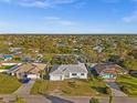 Aerial view of a light blue house and surrounding neighborhood at 1247 Graham Rd, Venice, FL 34293