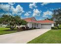 Single story home exterior with tile roof, attached garage, and landscaping at 1618 Slate Ct, Venice, FL 34292