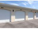 Three-car garage with individual overhead doors and numbered spaces at 200 Gardens Edge Dr # 212, Venice, FL 34285