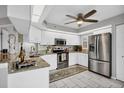 Modern kitchen featuring stainless steel appliances, granite countertops, and ample cabinet space at 804 Montrose Dr # 103, Venice, FL 34293