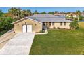 Single story home with attached garage and lush green lawn at 4646 Fallon Cir, Port Charlotte, FL 33948
