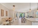 Bright kitchen features white cabinetry and an island at 1222 Collier Pl, Venice, FL 34293