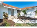 Well-lit front entry with updated door and landscaping at 16 Leeward Dr, Placida, FL 33946