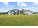 Modern house exterior with paved driveway at 8559 Waldrep St, Port Charlotte, FL 33981