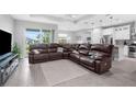Spacious living room with sectional sofa and kitchen view at 8559 Waldrep St, Port Charlotte, FL 33981