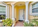 Front entrance with white columns and lush landscaping at 1704 Triano Cir # 1704, Venice, FL 34292