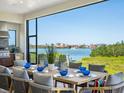 Outdoor dining area features a large table with seating and a beautiful waterfront view at 1109 Bayshore Rd, Nokomis, FL 34275