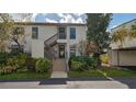 Condo building exterior featuring stairs and landscaping at 1130 Bird Bay Way # 184, Venice, FL 34285