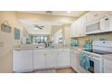 Bright kitchen with white cabinets and modern appliances at 1130 Bird Bay Way # 184, Venice, FL 34285