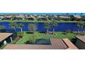 Aerial view of a waterfront home community with lush landscaping and canal views at 13848 Rinuccio St, Venice, FL 34293