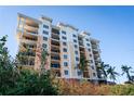 Stunning multi-story condo building with balconies, stucco siding, and lush landscaping offering a luxurious coastal lifestyle at 147 Tampa E Ave # 202, Venice, FL 34285