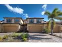 Beautiful townhome exterior featuring a two-car garage, brick driveway, desert landscaping, and neutral color palette at 20190 Ragazza Cir # 202, Venice, FL 34293
