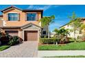 Two-story townhome with a two-car garage and neatly landscaped front yard at 20391 Lagente Cir, Venice, FL 34293