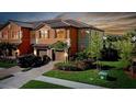 Attractive two-story townhome with a two-car garage and nicely landscaped front yard at 20391 Lagente Cir, Venice, FL 34293