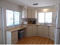 Well-lit kitchen boasts spacious countertops, a convenient workspace, and white appliances at 359 Longwood Dr, Venice, FL 34285