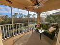 Spacious screened balcony with seating and canal views at 4213 Vicenza Dr # D2, Venice, FL 34293