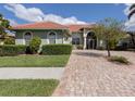 Exterior view of a single-Gathering home with well-manicured landscaping at 4245 Via Del Villetti Dr, Venice, FL 34293
