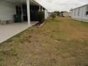 Lawn of property featuring ground cover, mulch beds and a side patio at 6234 Parakeet Rd, Englewood, FL 34224