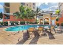 Inviting community pool with comfortable lounge chairs at 147 Tampa E Ave # 202, Venice, FL 34285
