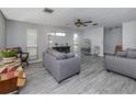 Living room with gray sofas and wood-look floors at 1571 S Venice Blvd, Venice, FL 34293