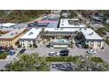 Aerial view of condo complex featuring a pool and surrounding parking at 200 Park N Blvd # 103, Venice, FL 34285