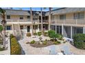 Relaxing courtyard with landscaping, seating, and a fountain at 200 Park N Blvd # 103, Venice, FL 34285