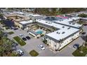 Aerial view of a condo complex with a pool and ample parking at 200 Park N Blvd # 103, Venice, FL 34285