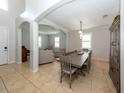 Bright dining room with a large table and views to living room at 2182 Nettlebush Ln, Venice, FL 34292