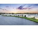 Waterfront community of manufactured homes at sunset at 472 Sharks Pt, North Port, FL 34287