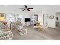 Bright living room featuring comfy seating and a view to the lanai at 605 Apple Ln, Englewood, FL 34223