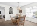 Charming dining area with a glass-top table and four chairs at 605 Apple Ln, Englewood, FL 34223
