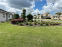 Houses in a quiet neighborhood with lush green lawns and landscaping at 139 Ibiza Loop, Venice, FL 34292