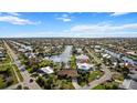 Beautiful aerial view of the neighborhood and canals with ocean in the distance at 1701 Boca Raton Ct, Punta Gorda, FL 33950