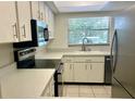 Kitchen with white cabinets and stainless steel appliances at 2260 Stickney Point Rd # 304, Sarasota, FL 34231