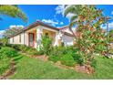 Single-story home with a red front door and nicely landscaped yard at 257 Teramo Way, Nokomis, FL 34275