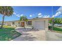 House exterior showcasing a driveway and palm trees at 261 Malvern Dr, Venice, FL 34293