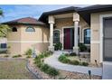 Well-maintained home with a welcoming front entrance and landscaped walkway at 3390 Dover Dr, Punta Gorda, FL 33983