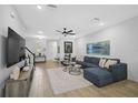 Bright living room with hardwood floors, sectional sofa, and large artwork at 4008 Via Sienna Cir, Sarasota, FL 34243