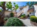 Condo exterior featuring stairs, landscaping, and walkway at 688 Bird Bay Cir # 27, Venice, FL 34285