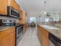 Modern kitchen featuring granite countertops and stainless steel appliances at 900 San Lino Cir # 922, Venice, FL 34292