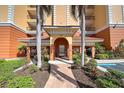 Condo building entryway with gated access and landscaping at 147 Tampa Ave # 303, Venice, FL 34285